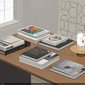 Stacks of Various Books on Wooden Table with Window Shutters and Geometric Wall Art