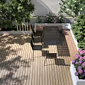 Outdoor Landscape Seating Space With Fire Pit Green Plants And Wooden Deck