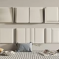 White Upholstered Headboards Arranged On Wall With Bed Pillows Magazine And Plant Decor