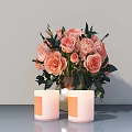 Pink Roses and Green Leaves in Vase with Two White Candles on Gray Tabletop Background