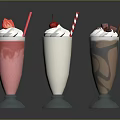 Pink White And Chocolate Milkshakes With Fresh Fruit And Chocolate Shavings In Glass Cups