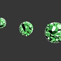 Three Green Crystal Like Decorative Pieces On Black Reflective Bases