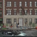 Red Brick Building Street Scene With Pedestrians Cars And Green Plants