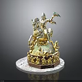 Golden Man Sculpture Riding Horse Holding Colorful Object Surrounded By Small Figurines On Circular Base