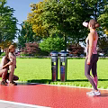 Outdoor Trash Bins With Green Grass Trees And Adult Child Nearby