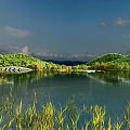Tranquil Natural Scenery With Lake Reflections Green Mountains Trees Bridge And Blue Sky