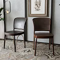 Elegant Leather Dining Chairs With Metal Frames Against Wall And Green Plants On Patterned Rug