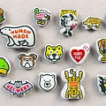 Colorful Assorted Cartoon Badges Featuring Animal Designs Human Made Logos And Food Icons