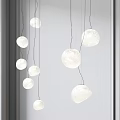 Multiple Modern Textured Paper Round Pendant Lights Hanging In Minimalist Interior Space