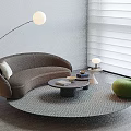 Curved Gray Sofa Round Coffee Table Set with Green Accent Chair Floor Lamp Geometric Rug