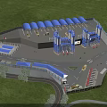 Industrial Factory Aerial View With Green Forest Surroundings Blue Roof Structures Roadways And Vehicles