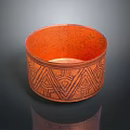 Orange Bowl Shaped Carved Sculpture With Intricate Geometric Patterns On Surface