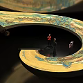 Spiral Art Installation With Traditional Landscape Patterns And Miniature Figures In Center