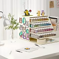 Building blocks storage shelf with cartoon stickers and Pokemon figures holding paint bottles on desktop
