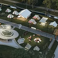 Scenic Camping Site With Multiple Tents Circular Structure Water Area And Green Grassland