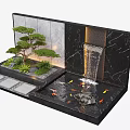 Decorative Water Fountain With Flowing Water Stones And Green Plants In Miniature Landscape