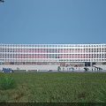 Modern Library Building With Striped Glass Facade Green Lawn Trees Front Entrance And Illuminated Exterior