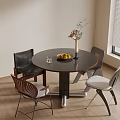 Black Round Dining Table Set With Four Various Design Chairs Vase Fruit Bowl Wooden Floor