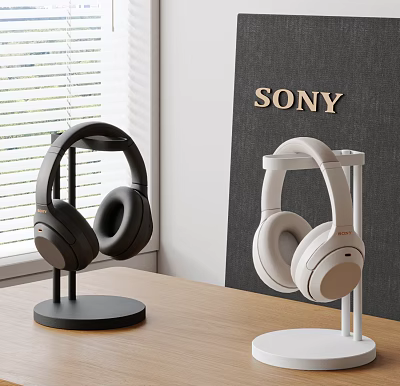 Sony Black and White Headphones Displayed on Stands in Modern Desktop Setup 3d model
