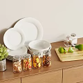 White Dinnerware Set with Plates Bowls Glass Jars Limes Green Plant on Wooden Countertop