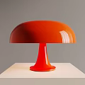 Orange Table Lamp With Round Shade And Red Base On White Pedestal