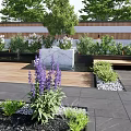 Tranquil Courtyard Garden with Wooden Deck Small Pond Green Plants and Outdoor Dining Set