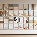 Abstract Wall Art Collection Featuring Neutral Tones And Diverse Paintings On White Wall