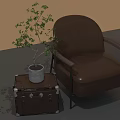 Brown Leather Armchair With Leather Trunk Side Table And Potted Plant