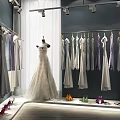 Elegant Bridal Dresses Hanging In Boutique With Mannequin And Colorful High Heels