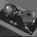 Modern Kitchen Utensils on Black Cooktop with Silver Teapot Covered Pot and Floral Patterns