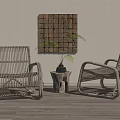 Two Rattan Leisure Chairs With Small Wooden Table Potted Fern And Decorative Wall Art On Wooden Floor