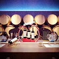 Elegant Wine Cellar Interior With Wooden Barrels Long Table And Wine Glasses