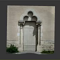 Beige Wall Arched Entrance Gate With Wooden Door Stone Pillar Decorations And Green Plants Path