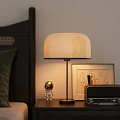 Bedside Table Setup With Table Lamp Astronaut Figurine Radio And Wall Painting