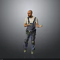 Male Worker In Denim Overalls With Knee Pads Standing And Gesturing On Gray Background