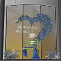 Heart Shaped Blue Floral Display In Front Of Glass Window With Green Chair And Bouquets
