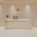 Curved Light Colored Store Front Desk With Laptop Green Plant And Logo On Beige Wall
