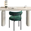 Cream Colored Desk With Open Book White Coffee Cup Stacked Decorative Objects And Green Chair