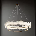 Modern Chandelier With White Circular Shades And Gold Metal Rings Hanging In Dark Interior
