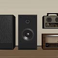 Black Stereo Speakers and Vintage Radios on Wooden Floor Against Beige Wall with Classic Design