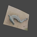 Realistic Crocodile Sculpture Lying On Sandy Surface With Detailed Textured Skin