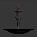 Elegant Bronze Candlestick With Lit Candle And Ornate Round Base Design