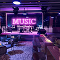 Hard Rock Bar Interior With Purple Lighting Music Neon Sign And Stage Seating Area
