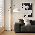 Modern Arc Floor Lamp with White Shade Beside Black Leather Sofa and Abstract Wall Art