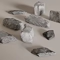 Natural Gray Stones In Various Shapes And Sizes On Light Gray Background Surface