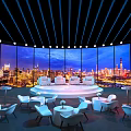 Modern Event Space With Round Stage Large Screen City Night View And White Seating