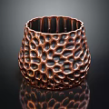 Metallic Copper Vase With Intricate Honeycomb Texture On Black Background And Reflection