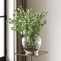 Decorative Glass Vase With Fresh Green Foliage On Metal Table By Window