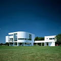 Modern Detached Villa With White Exterior Large Windows Green Lawn And Blue Sky