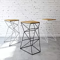 Modern Geometric Bar Stools With Metal Frames And Wooden Seats Against Brick Wall